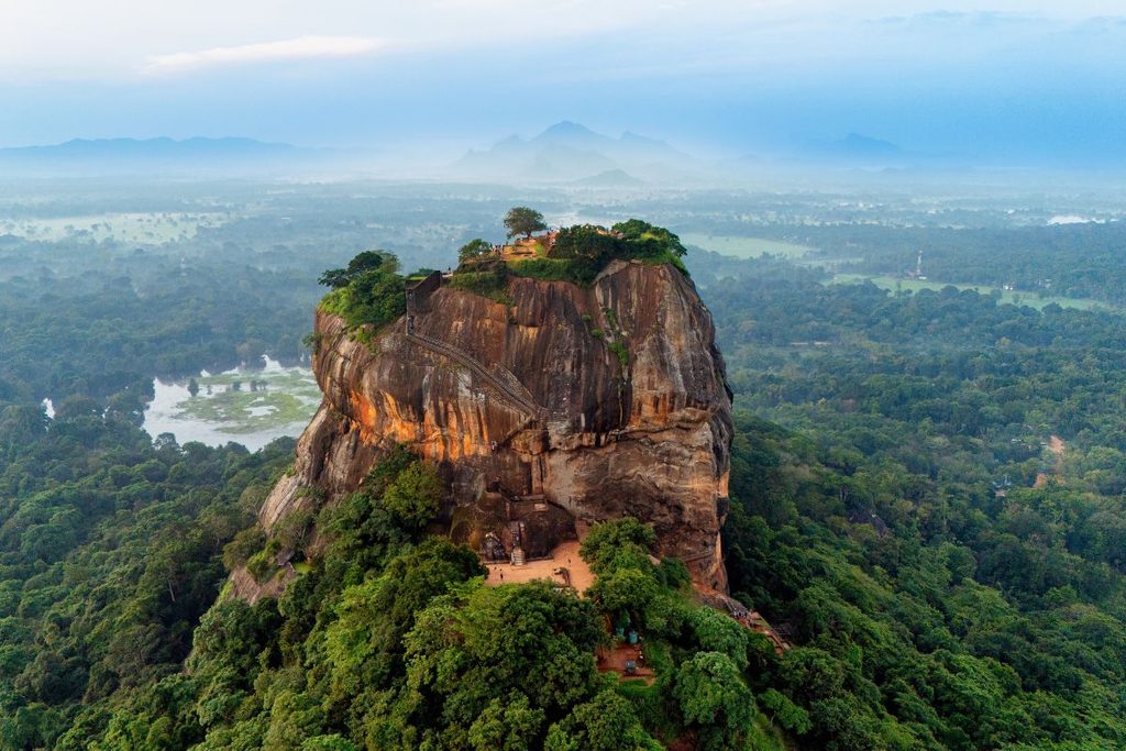 Sigiriya Rock rising above the surrounding green landscape in Sri Lanka